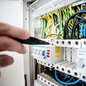 Electrician working on a fuse box